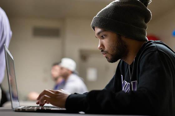 A student types on his computer in class